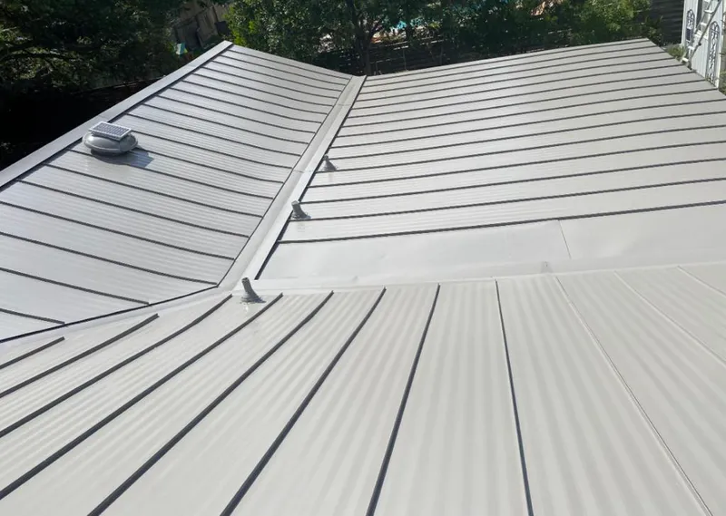 Solar attic fan installed on a metal roof for Roof Ventilation in Arcadia